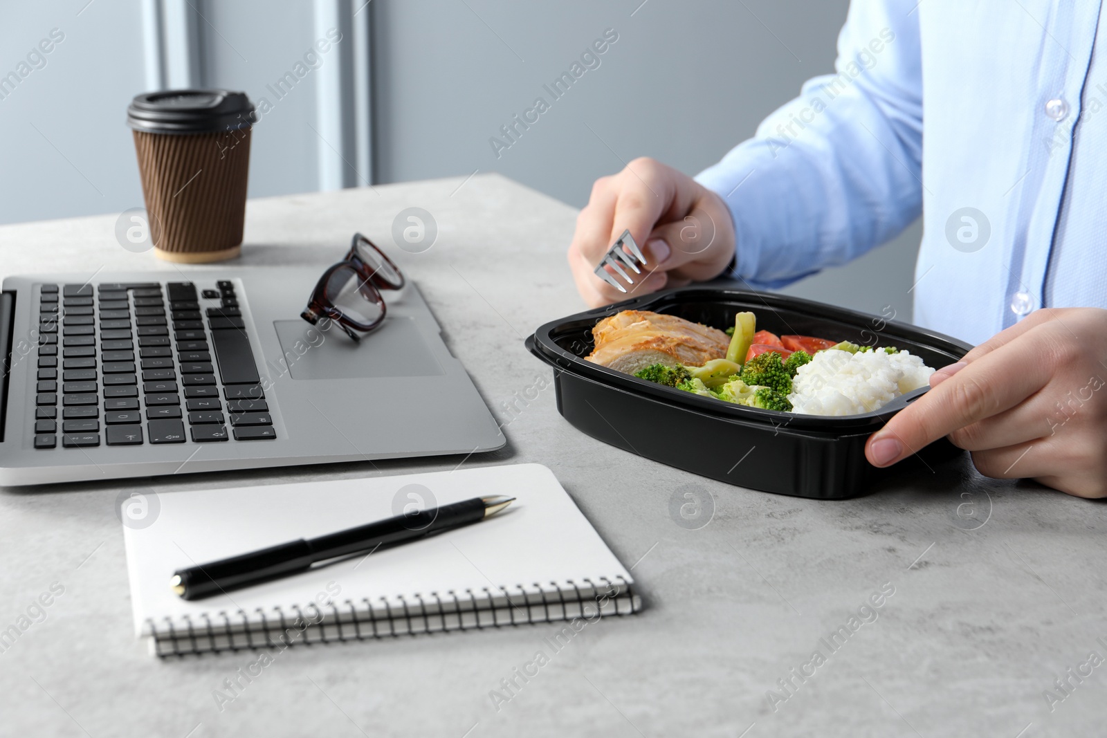 Photo of Office employee having business lunch at workplace, closeup