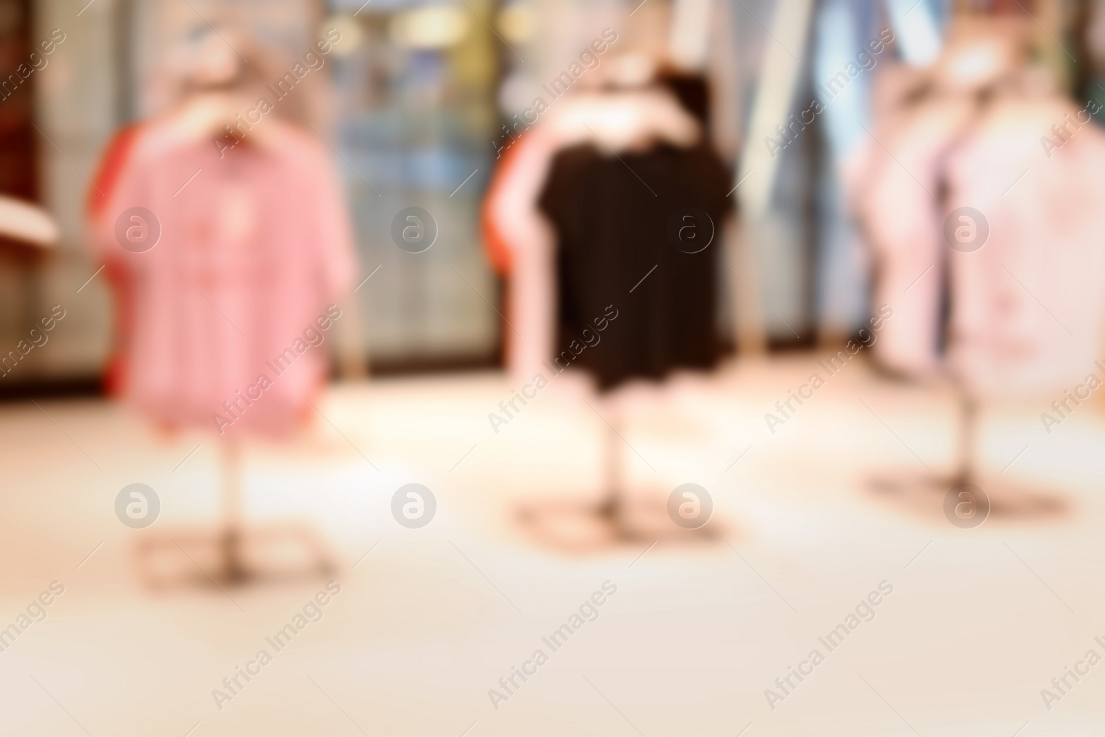 Photo of Blurred view of modern store with different clothes