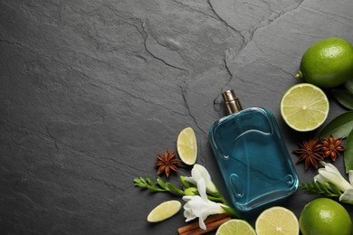 Flat lay composition with bottle of perfume and fresh citrus fruits on grey table. Space for text