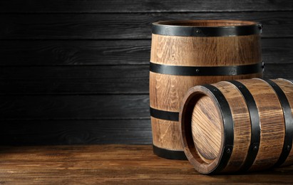 Photo of Wooden barrels on table, space for text