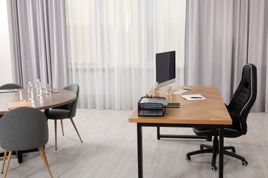 Photo of Stylish director's workplace with comfortable furniture in room. Interior design