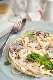 Photo of Delicious pasta with mushrooms and cheese on white table, closeup