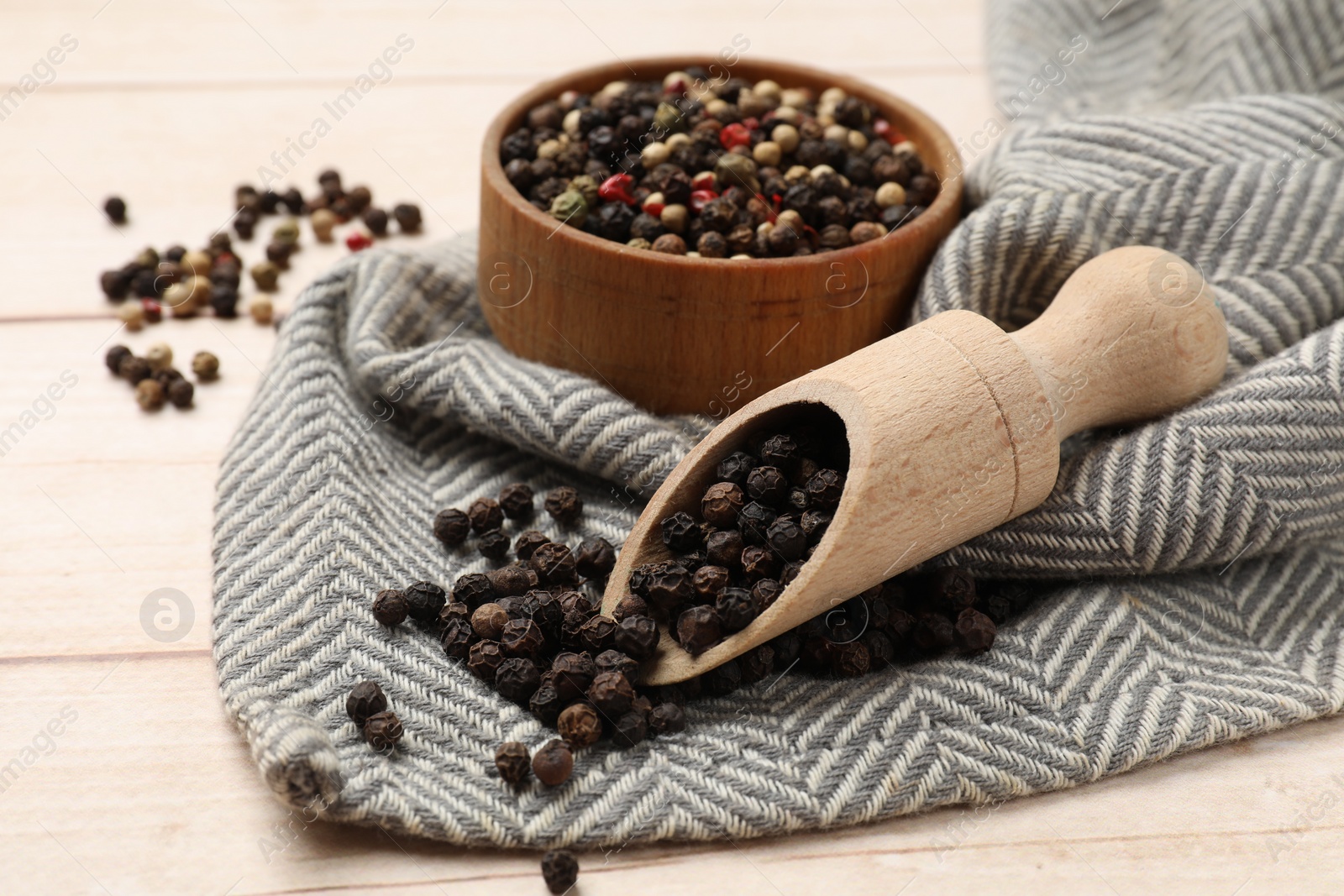 Photo of Aromatic spices. Different peppers on wooden table