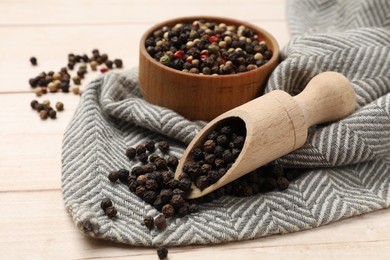 Photo of Aromatic spices. Different peppers on wooden table