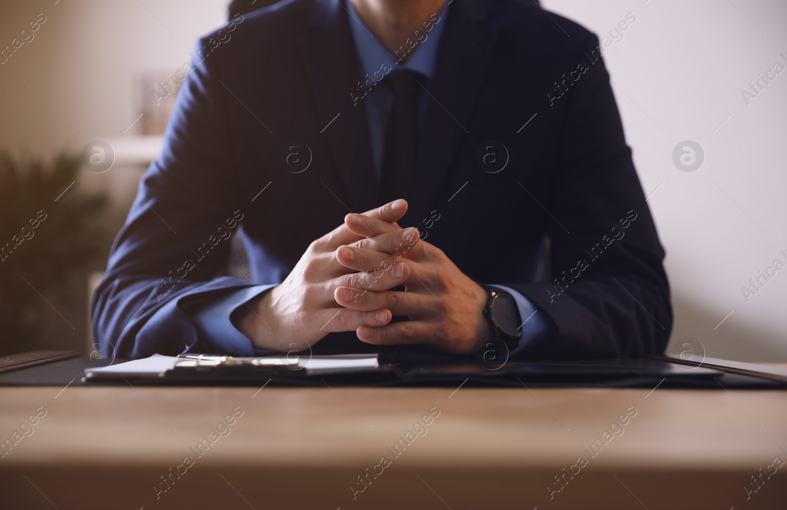 Photo of Male lawyer at table in office, closeup