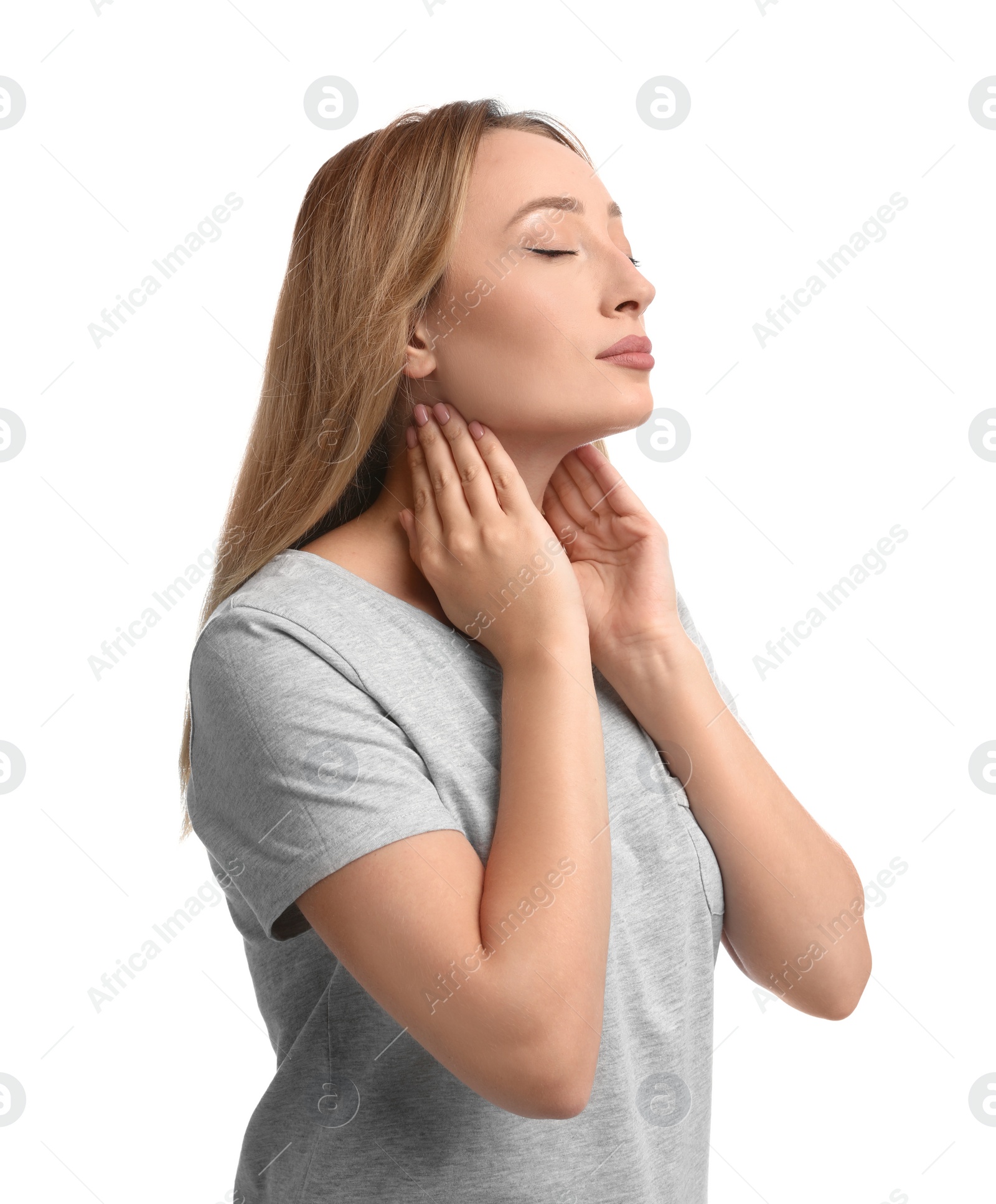 Photo of Young woman doing thyroid self examination on white background