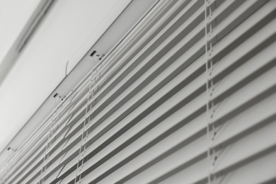 Photo of Closeup view of horizontal blinds on window indoors