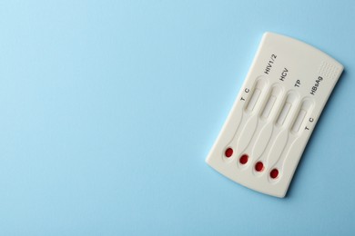 Photo of Disposable multi-infection express test on light blue background, top view. Space for text