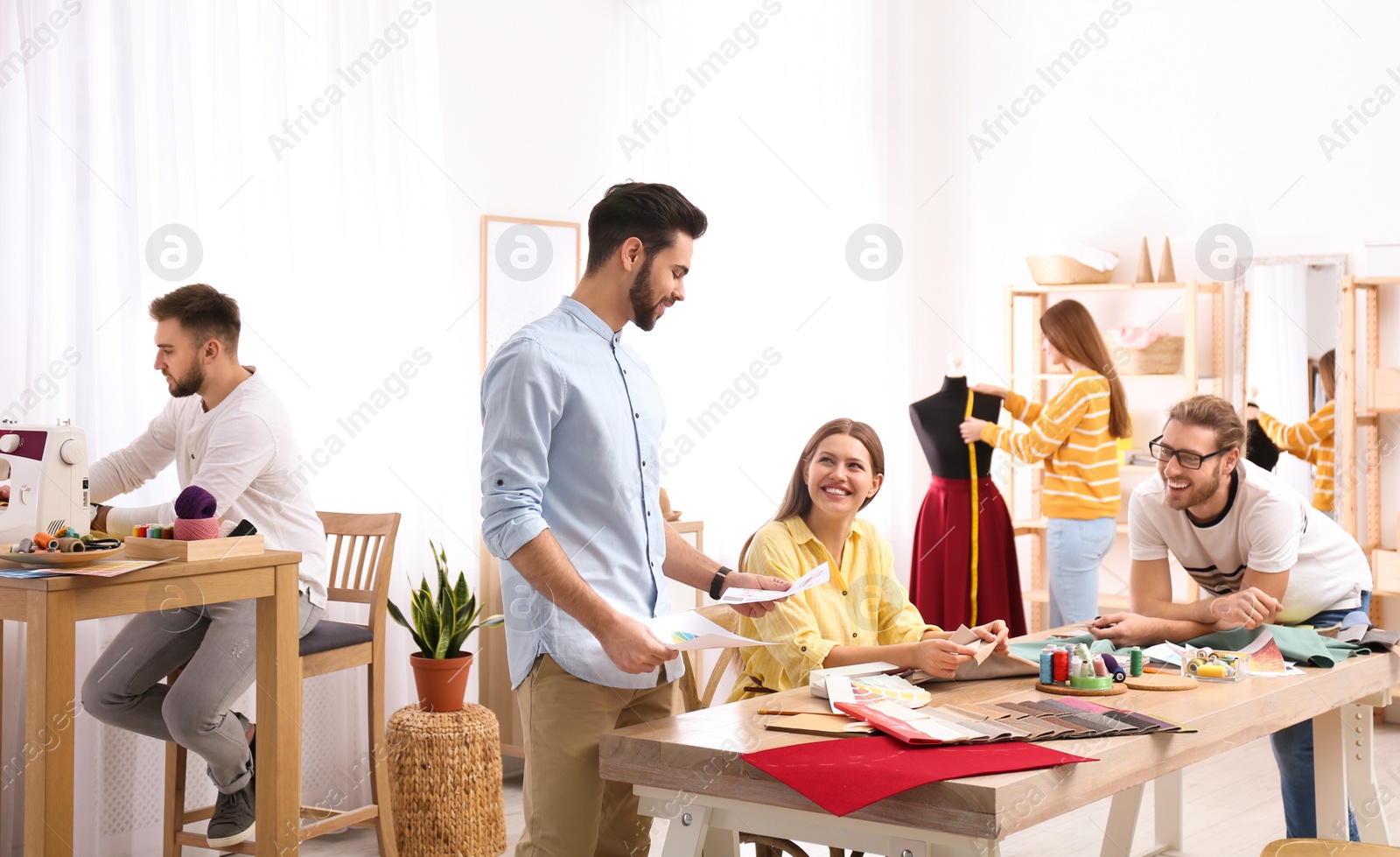 Photo of Fashion designers creating new clothes in studio