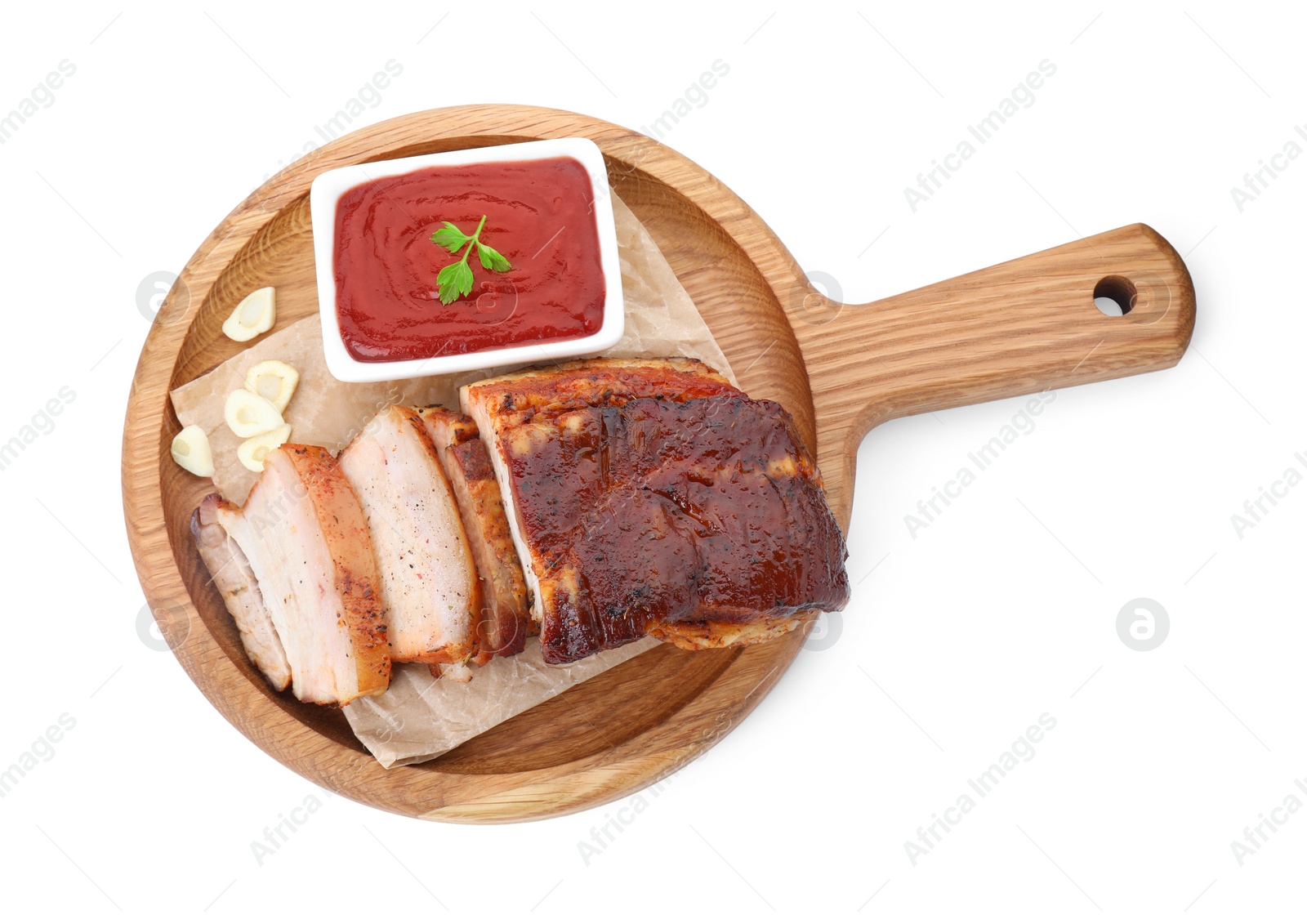 Photo of Pieces of tasty baked pork belly and sauce isolated on white, top view