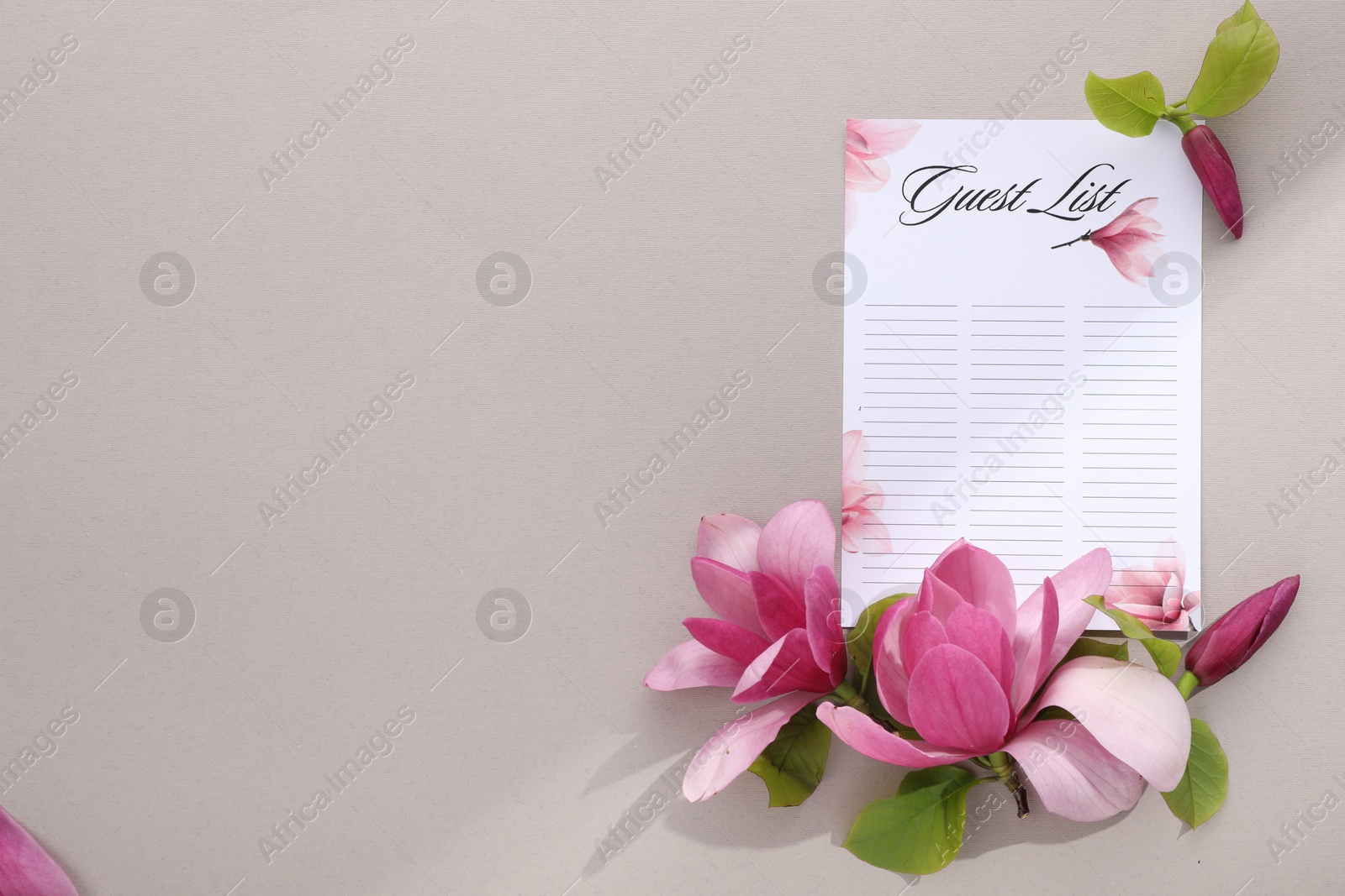 Photo of Guest list and beautiful flowers on grey background, flat lay. Space for text