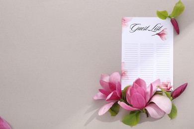 Guest list and beautiful flowers on grey background, flat lay. Space for text