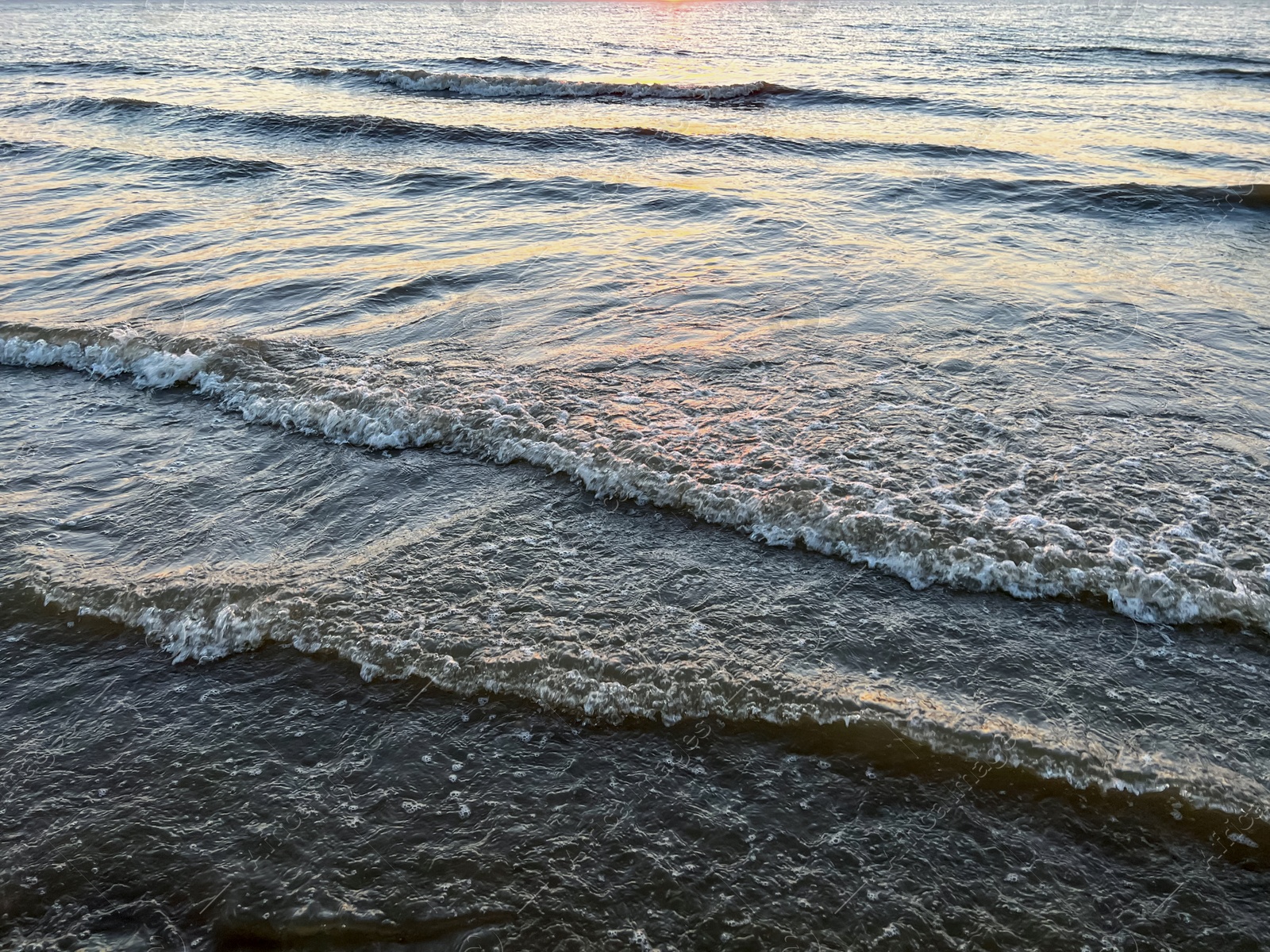 Photo of Beautiful view of sea waves at sunset