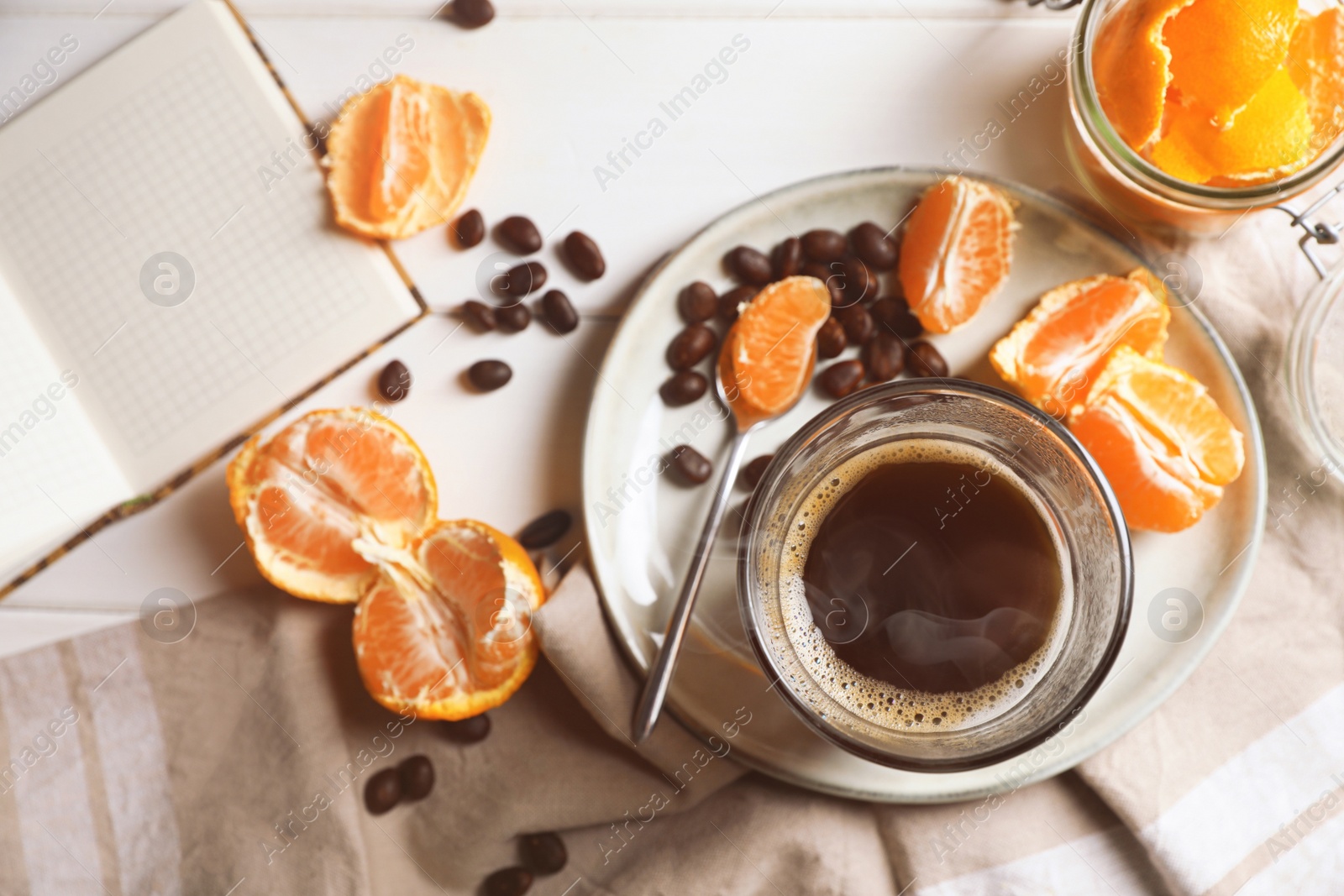 Photo of Flat lay composition with many fresh ripe tangerines and book on white wooden table