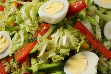 Delicious salad with Chinese cabbage and quail eggs as background, closeup