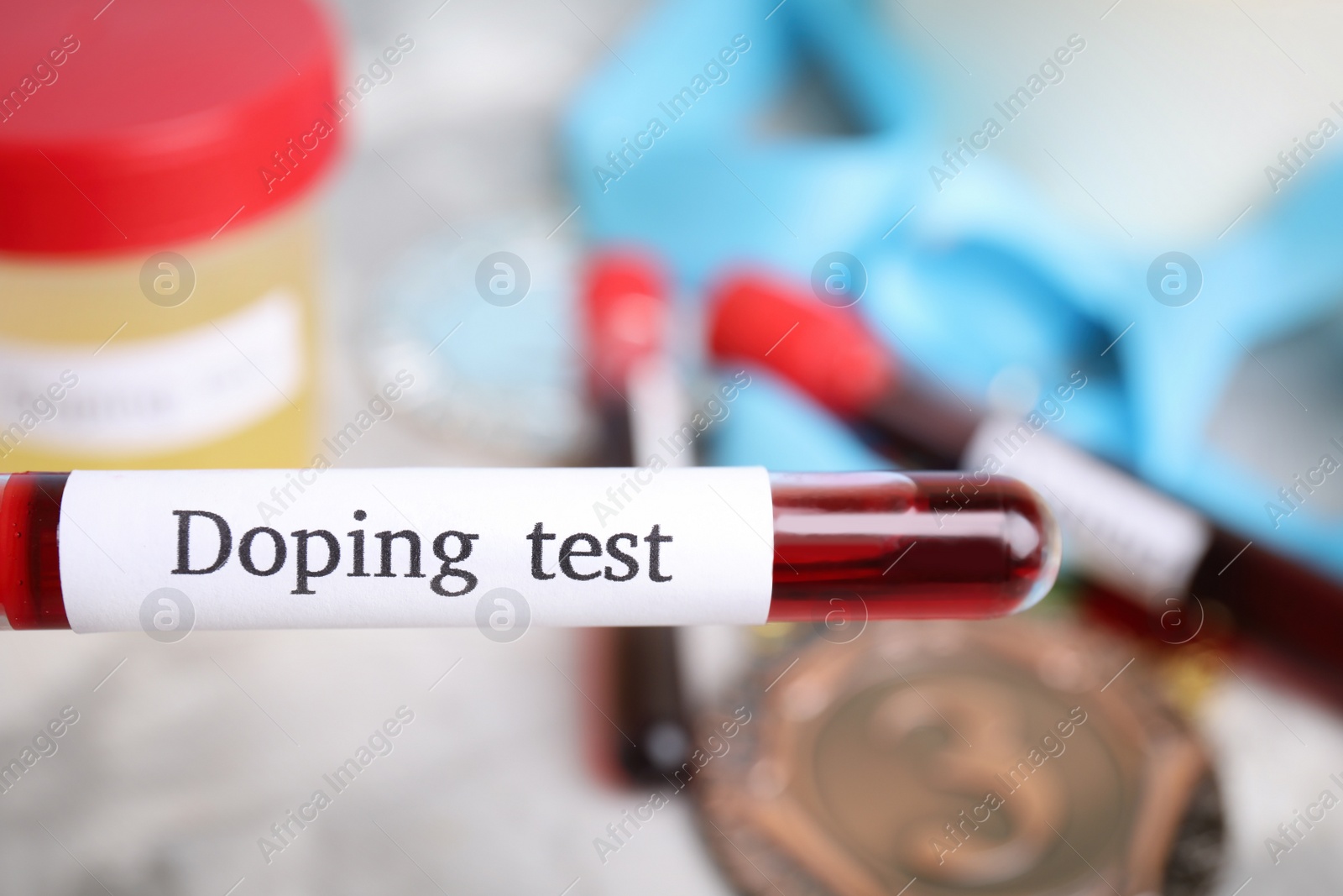 Photo of Tube of blood with words Doping test on blurred background, closeup