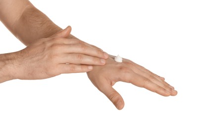 Photo of Man applying cream onto hand against white background, closeup