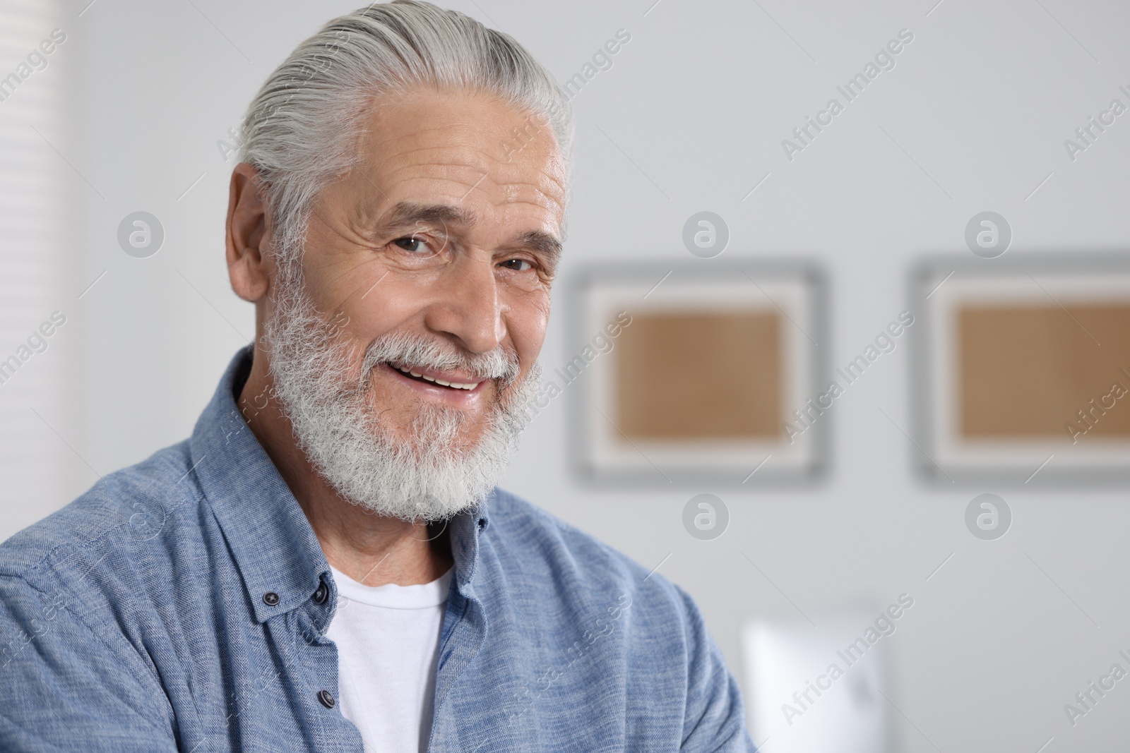 Photo of Portrait of handsome senior man in office. Space for text