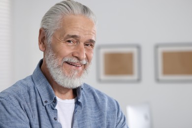 Portrait of handsome senior man in office. Space for text