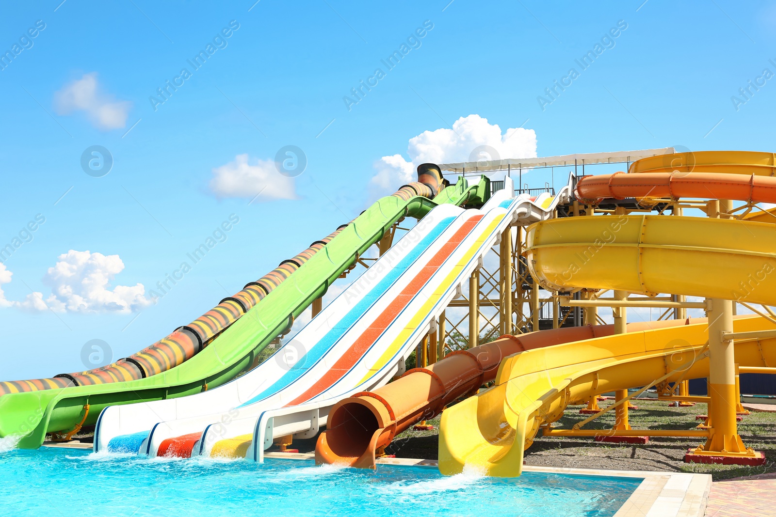 Photo of Different colorful slides in water park on sunny day