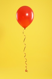 Photo of Bright balloon on color background. Celebration time