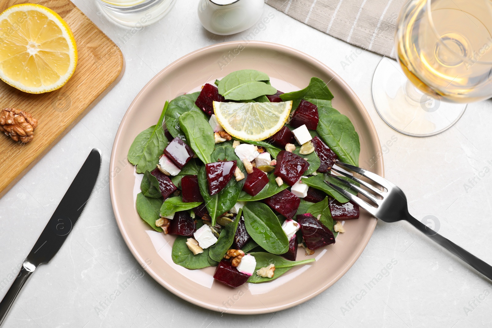 Photo of Delicious beet salad served on grey table, flat lay