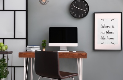 Photo of Comfortable workplace with computer on desk in home office