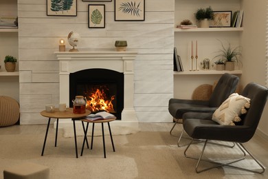 Photo of Stylish living room interior with comfortable chairs and decorative fireplace