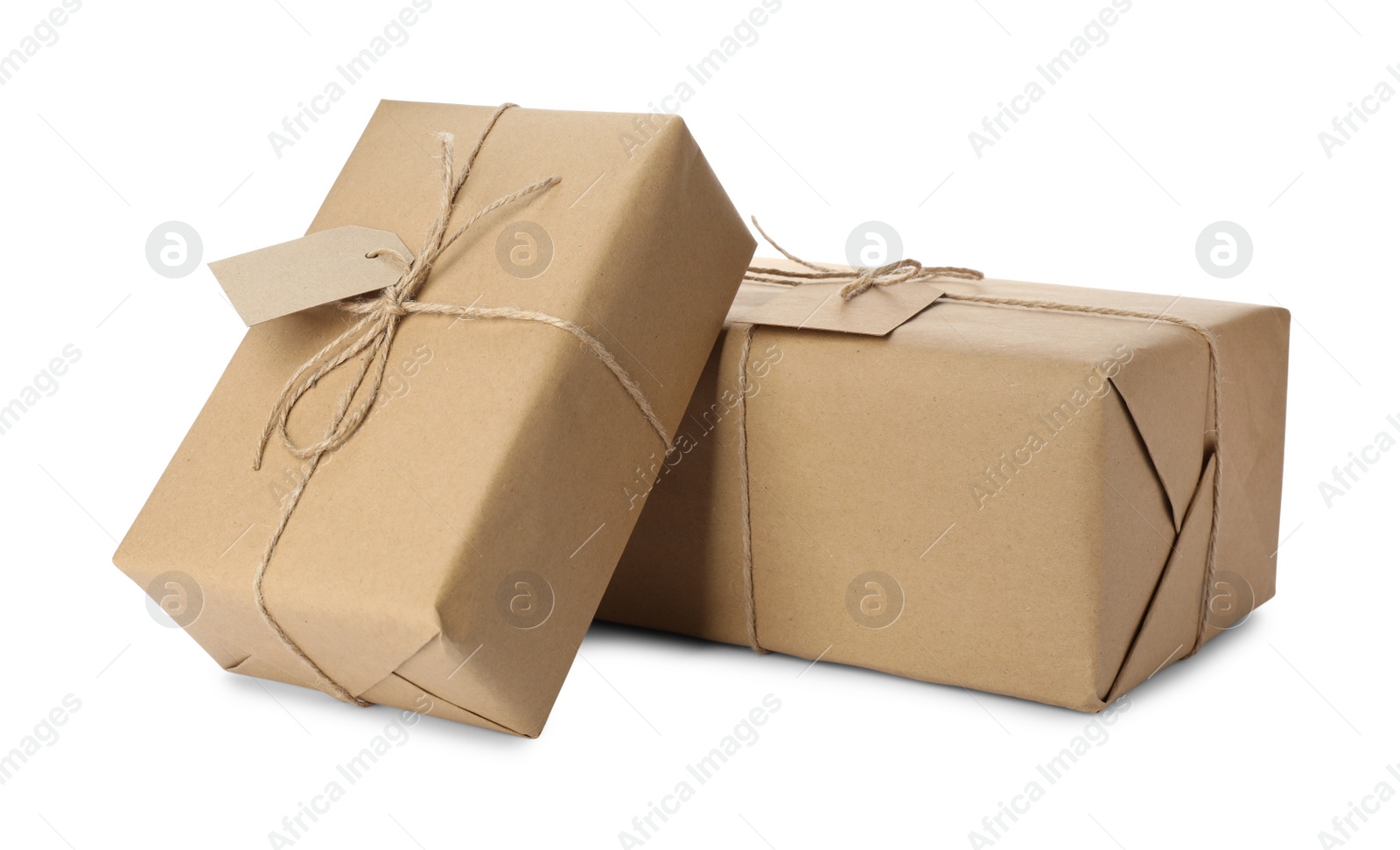 Photo of Parcels wrapped in kraft paper with tags on white background