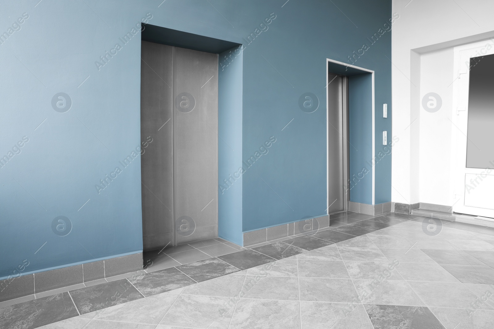 Photo of Closed stylish elevator doors in clean hall