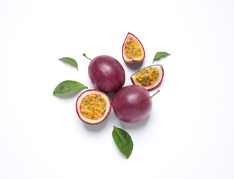 Photo of Fresh ripe passion fruits (maracuyas) with leaves on white background, flat lay