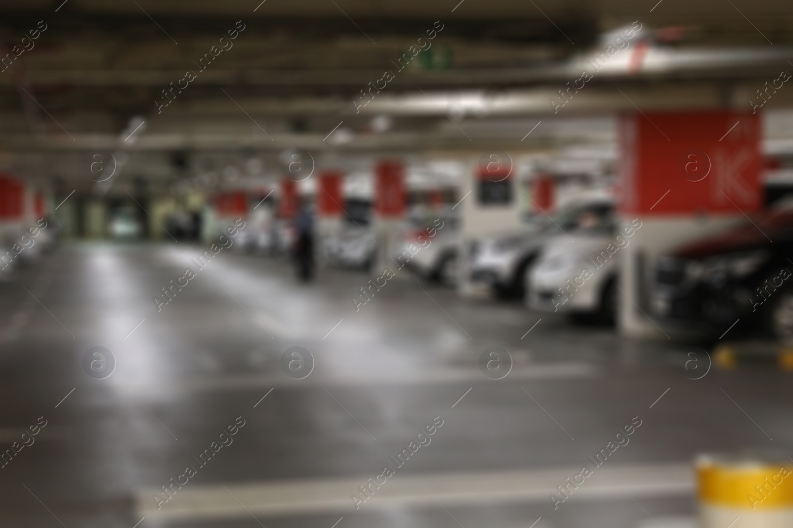 Photo of DUBAI, UNITED ARAB EMIRATES - NOVEMBER 04, 2018: Blurred view of underground parking garage with cars