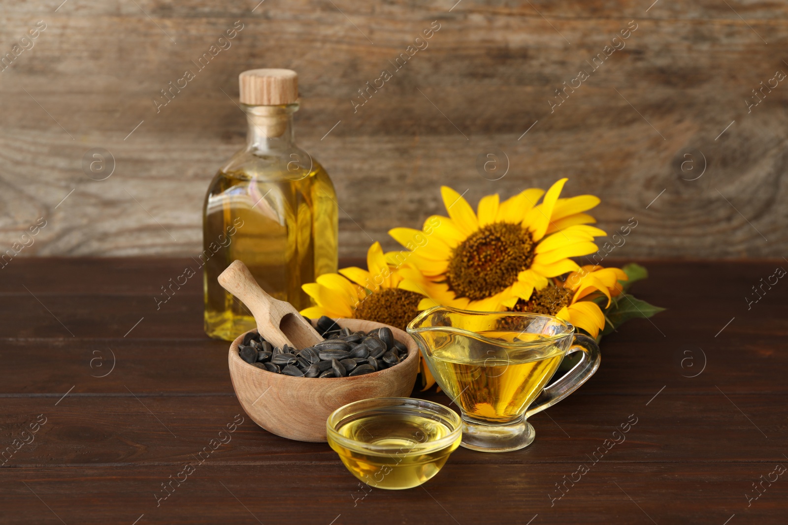 Photo of Composition with sunflower oil on wooden table