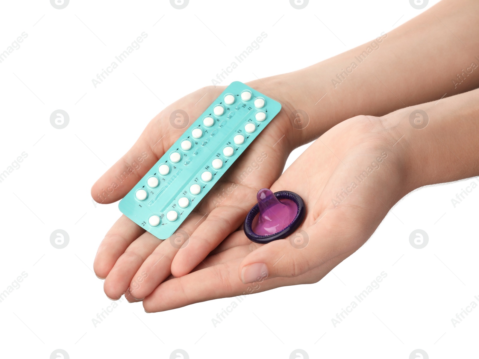 Photo of Young woman holding birth control pills and condom on white background, closeup. Safe sex concept