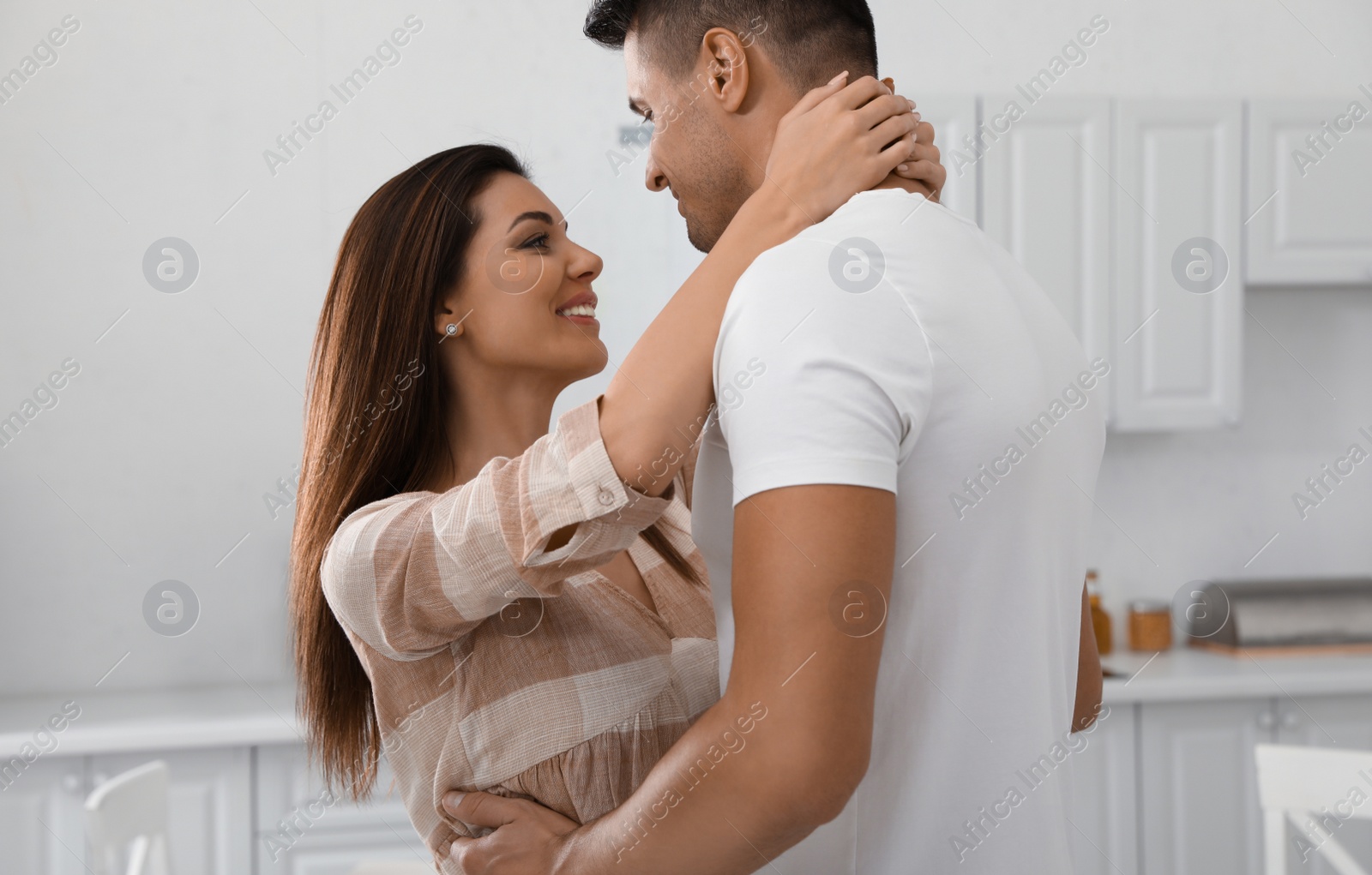 Photo of Happy couple dancing in kitchen at home