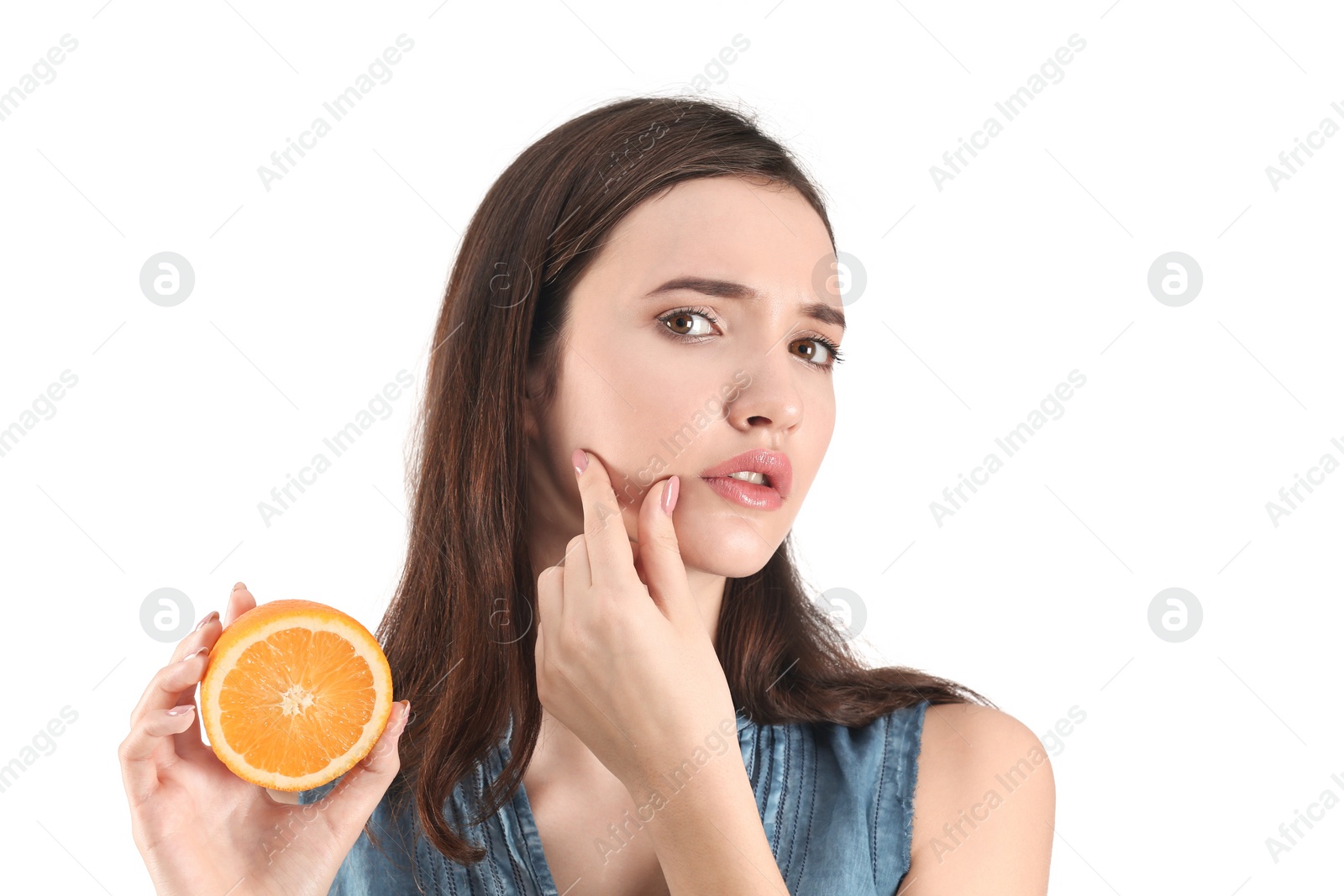 Photo of Teenage girl with acne problem holding orange against white background