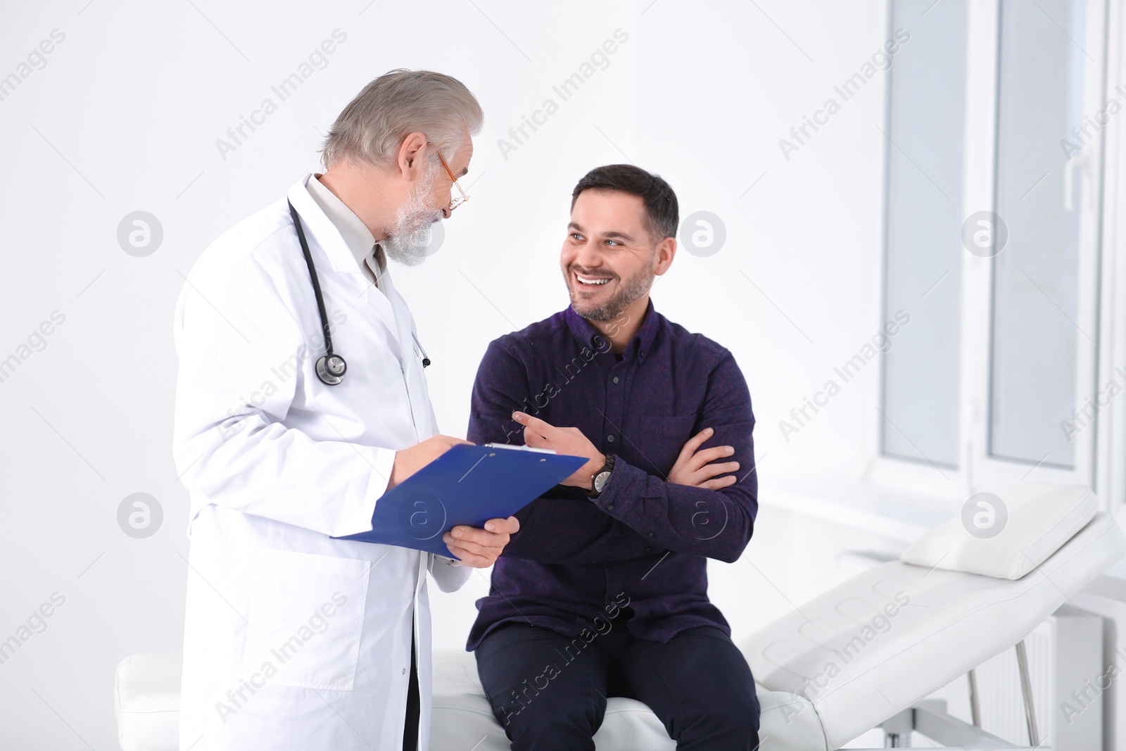 Photo of Patient having appointment with senior doctor in clinic