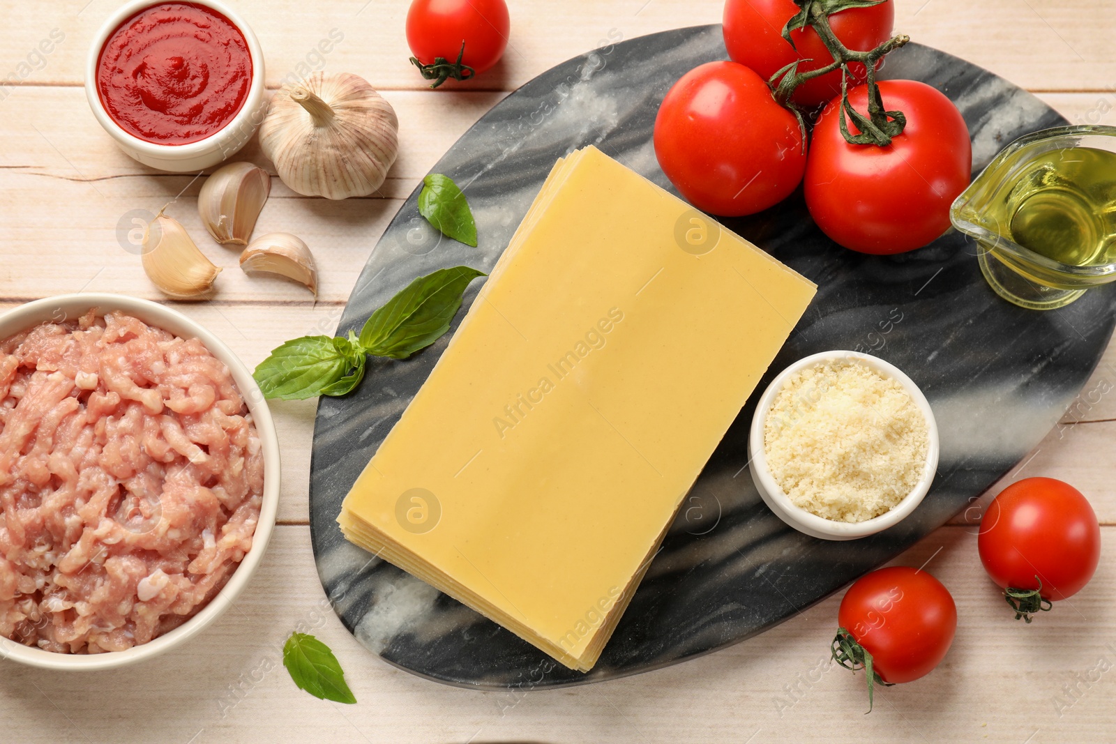 Photo of Ingredients for lasagna on white wooden table, flat lay