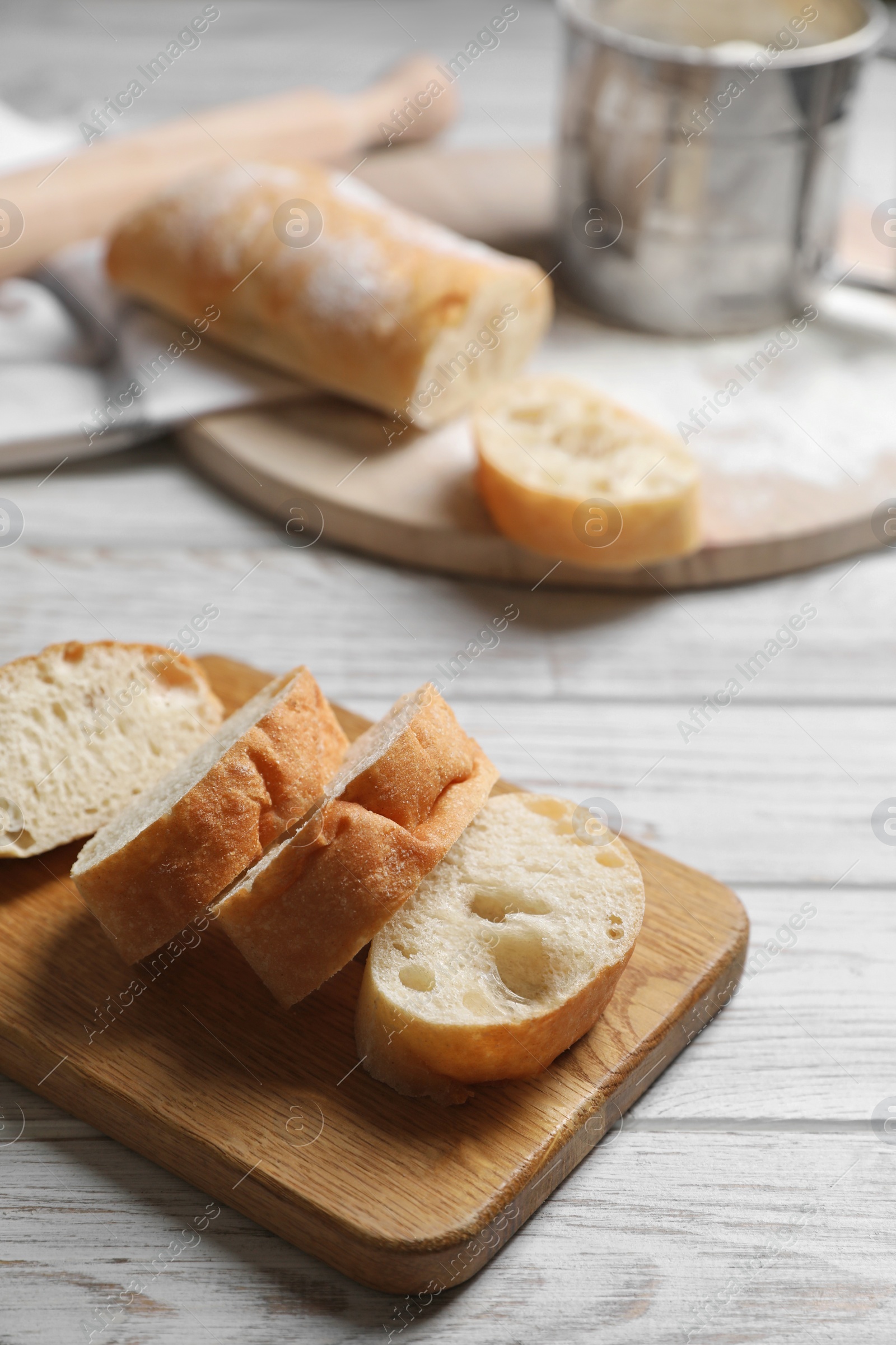 Photo of Fresh crispy ciabattas on white wooden table