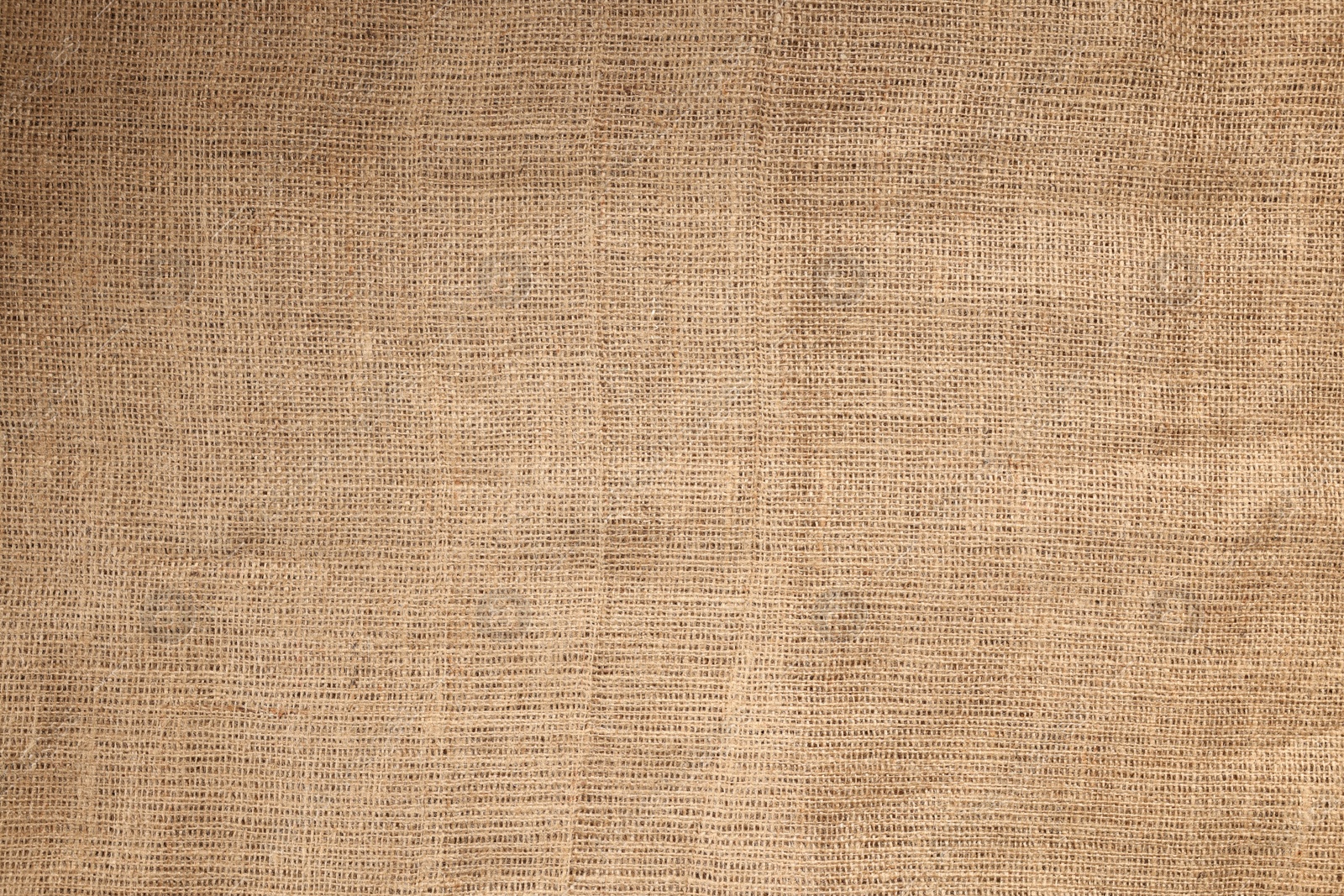 Photo of Texture of natural burlap fabric as background, top view