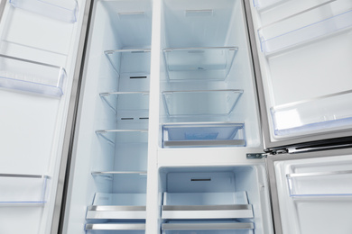 Shelves of empty modern refrigerator, closeup view