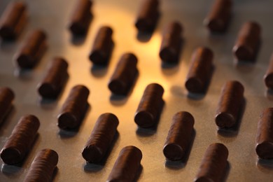 Many delicious chocolate candies on table, closeup. Production line