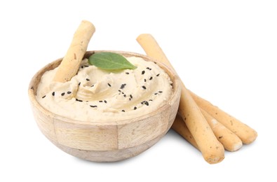 Photo of Delicious hummus with grissini sticks on white background