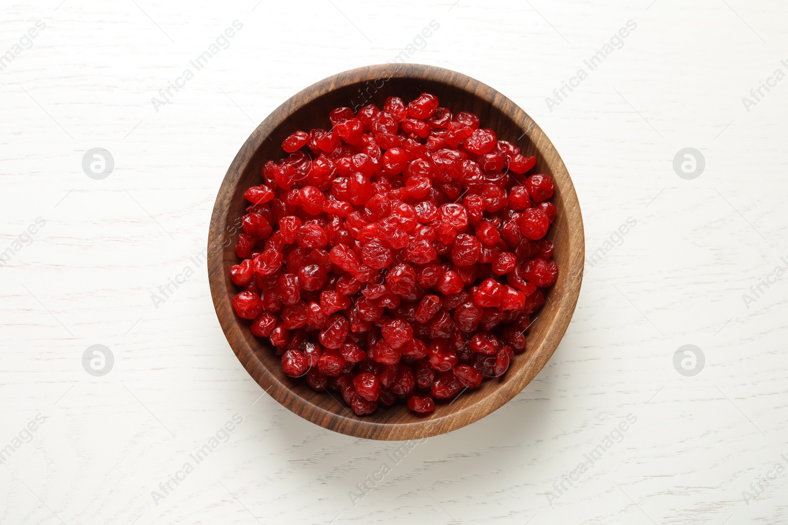 Photo of Bowl with tasty cherries on wooden background, top view. Dried fruits as healthy food