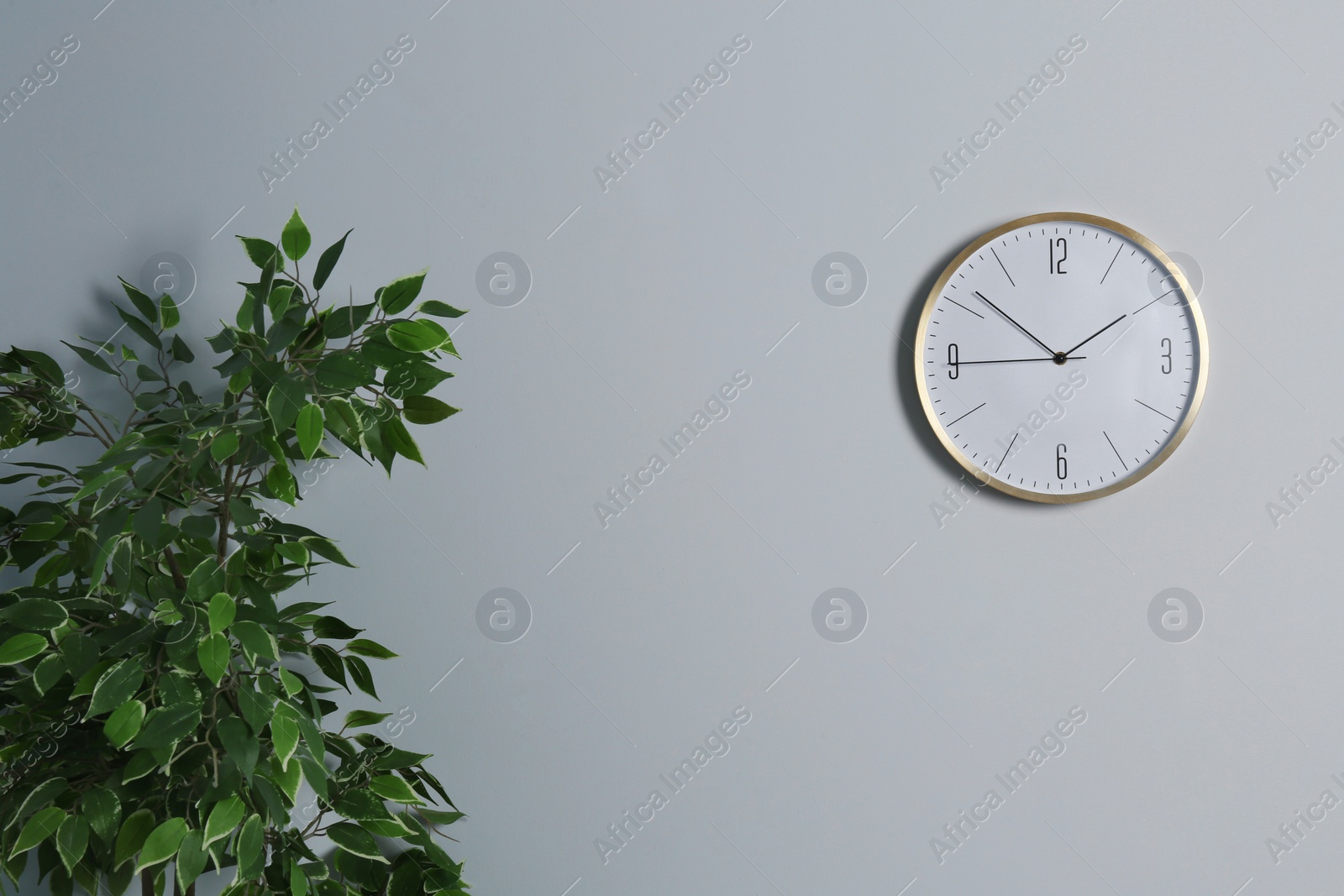 Photo of Stylish clock and space for text on wall indoors. Time management