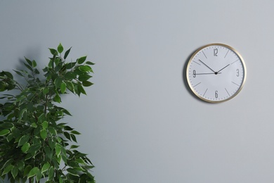 Stylish clock and space for text on wall indoors. Time management