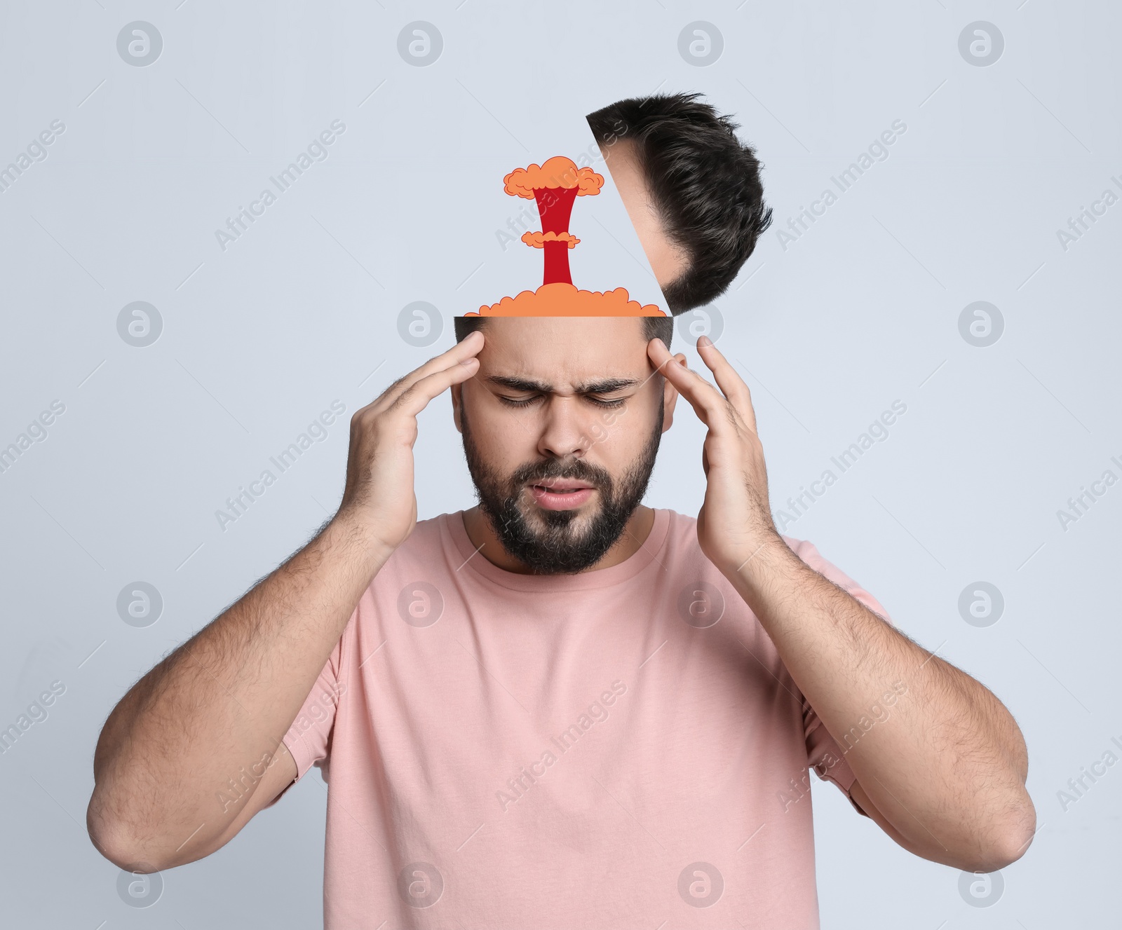 Image of Young man having headache on light background. Illustration of atomic explosion representing severe pain
