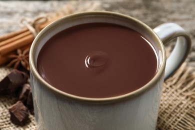 Photo of Yummy hot chocolate in mug on table, closeup