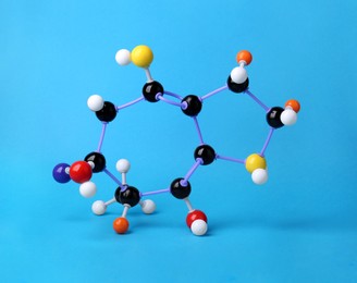 Photo of Structure of molecule on light blue background. Chemical model
