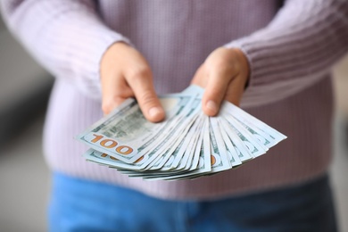 Photo of Woman with American money at home, closeup